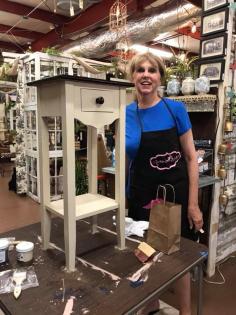 Lady painting a side table  